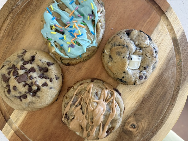 Assortment of Silly Goose Sweets gourmet cookies on a wooden board